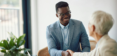 African-American man shaking hands with white female