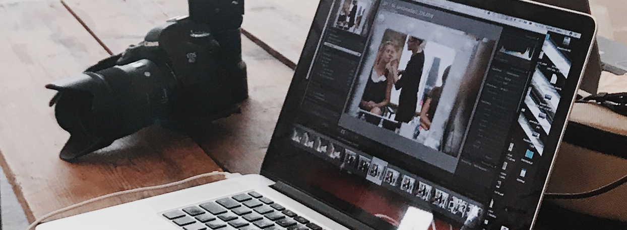 Camera and laptop sit on table